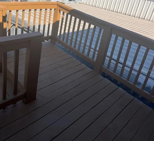 a view of balcony with wooden floor