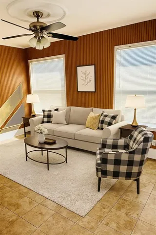 a living room with furniture a rug and a window