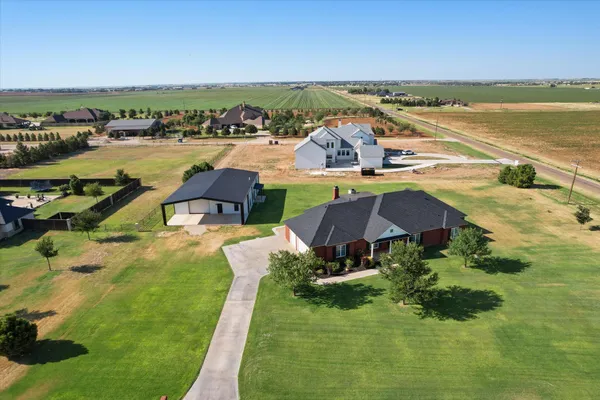 a front view of house with yard and outdoor seating