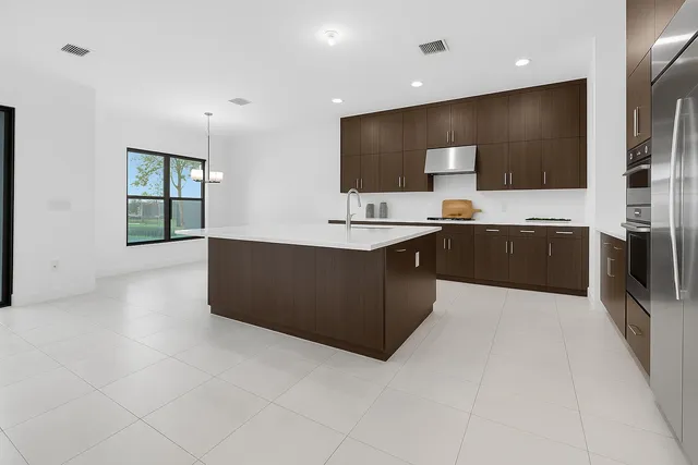 a kitchen with stainless steel appliances granite countertop a sink stove and cabinets
