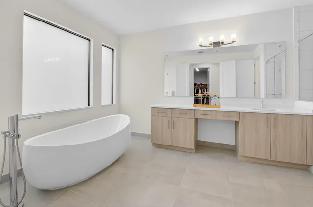 a bathroom with a granite countertop sink a toilet and a mirror
