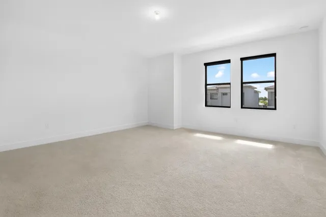 a bathroom with a granite countertop toilet a sink and a mirror