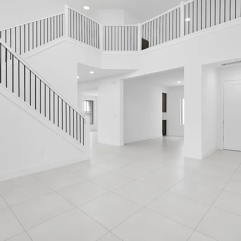 an empty room with a empty space and windows