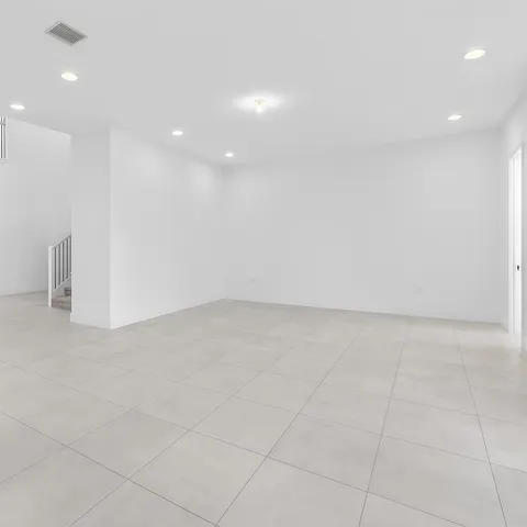 a large kitchen with stainless steel appliances a sink and cabinets