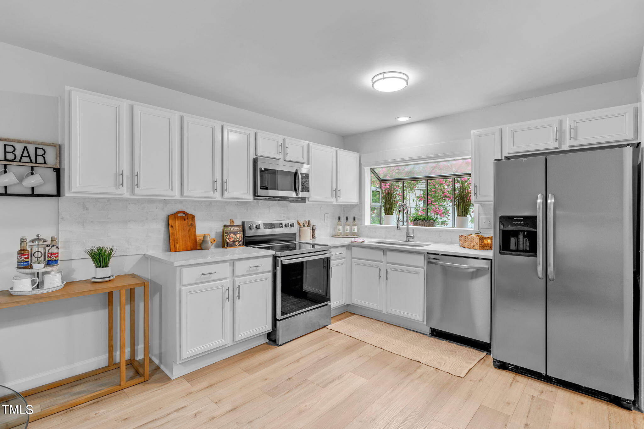 5805 Shamrock Road Durham, NC 27713 - Photo 4 of 19 a kitchen with a refrigerator cabinets and wooden floor