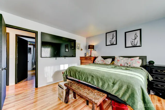 a bedroom with a bed and a flat screen tv