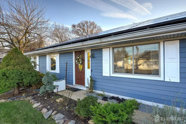 a front view of house with a garden