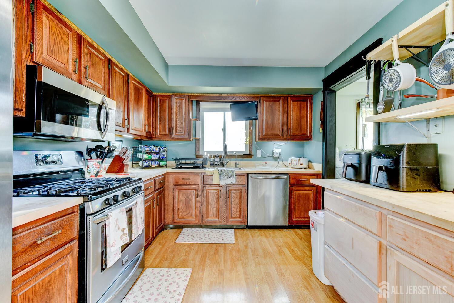 88 Stratton Street South Piscataway, NJ 08854 - Photo 9 of 28 a kitchen with stainless steel appliances granite countertop a stove sink microwave and cabinets
