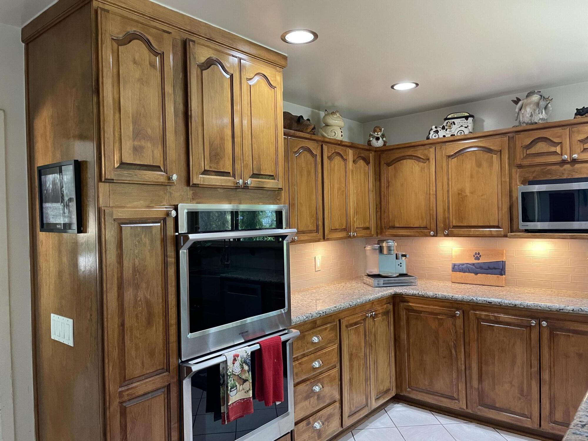 38540 Alva Drive Cherry Valley, CA 92223 - Photo 15 of 60 a kitchen with stainless steel appliances granite countertop a stove a sink and a microwave