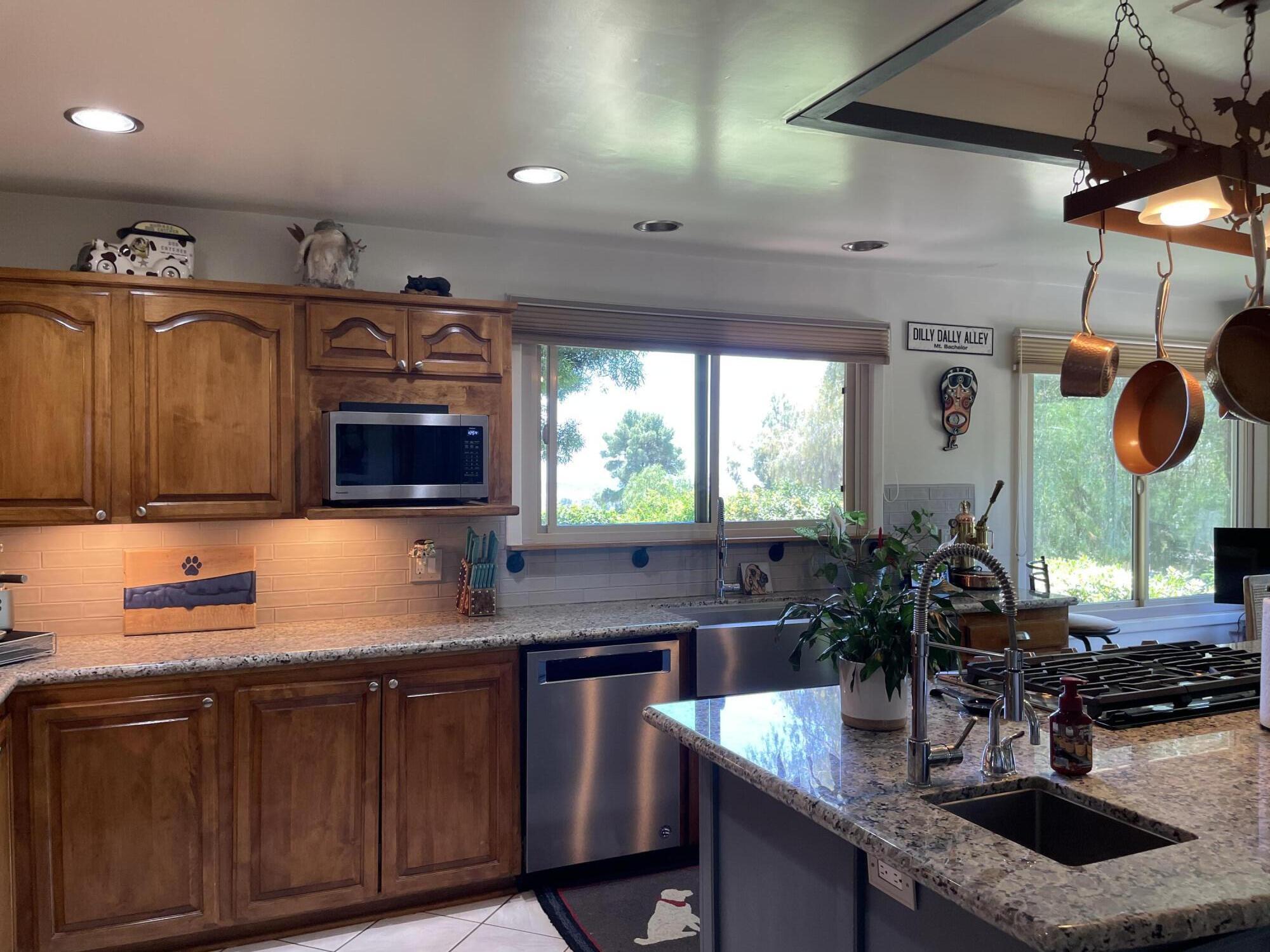 38540 Alva Drive Cherry Valley, CA 92223 - Photo 16 of 60 a kitchen with stainless steel appliances granite countertop a sink and a microwave