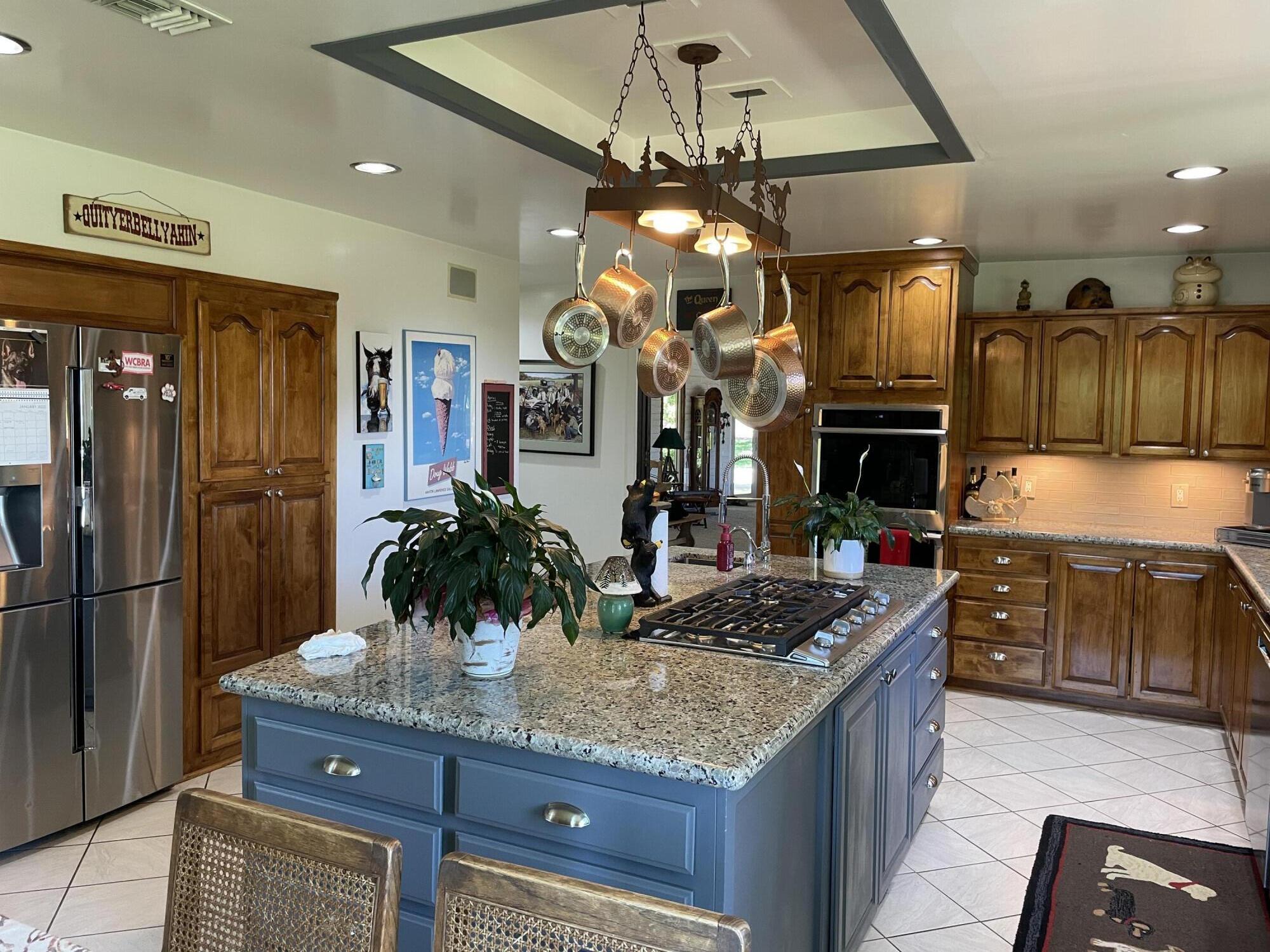 38540 Alva Drive Cherry Valley, CA 92223 - Photo 18 of 60 a kitchen with stainless steel appliances granite countertop a sink and a refrigerator