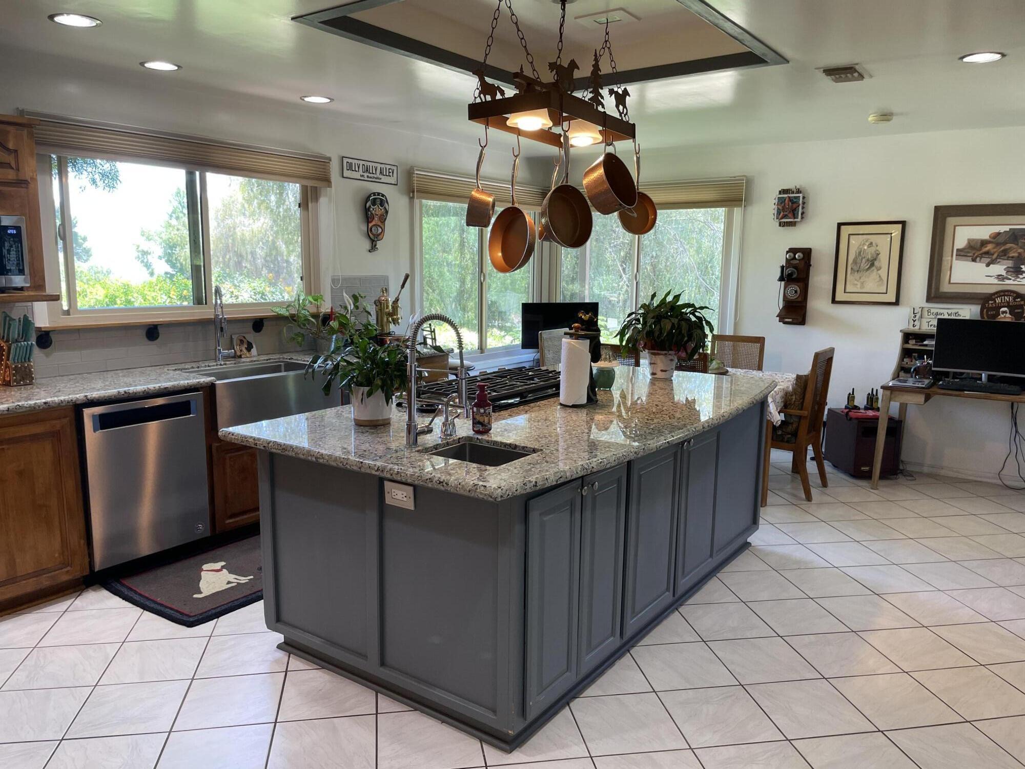 38540 Alva Drive Cherry Valley, CA 92223 - Photo 19 of 60 a kitchen with stainless steel appliances granite countertop a sink and a microwave