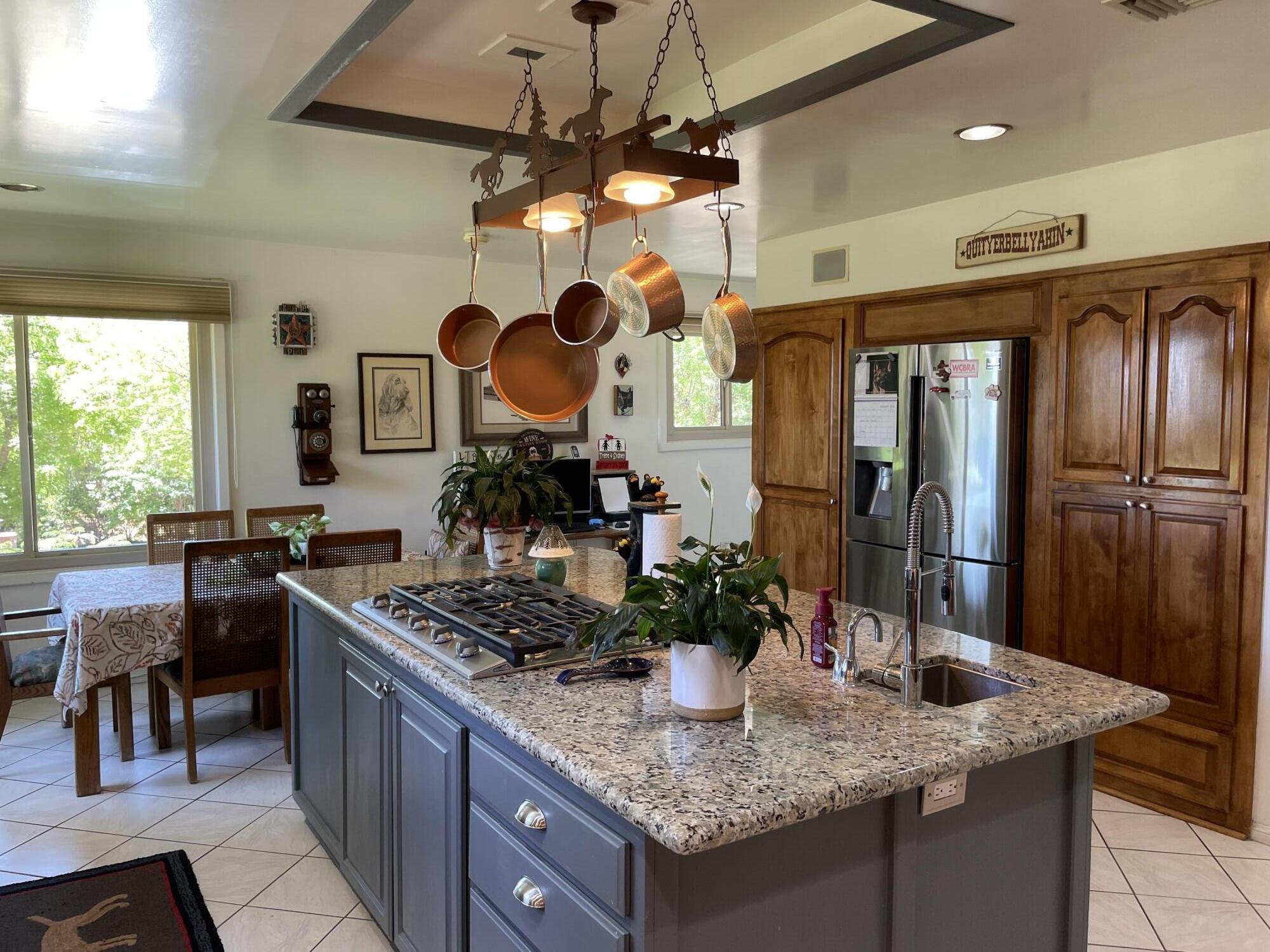 38540 Alva Drive Cherry Valley, CA 92223 - Photo 20 of 60 a kitchen with stainless steel appliances granite countertop a sink a stove and a refrigerator