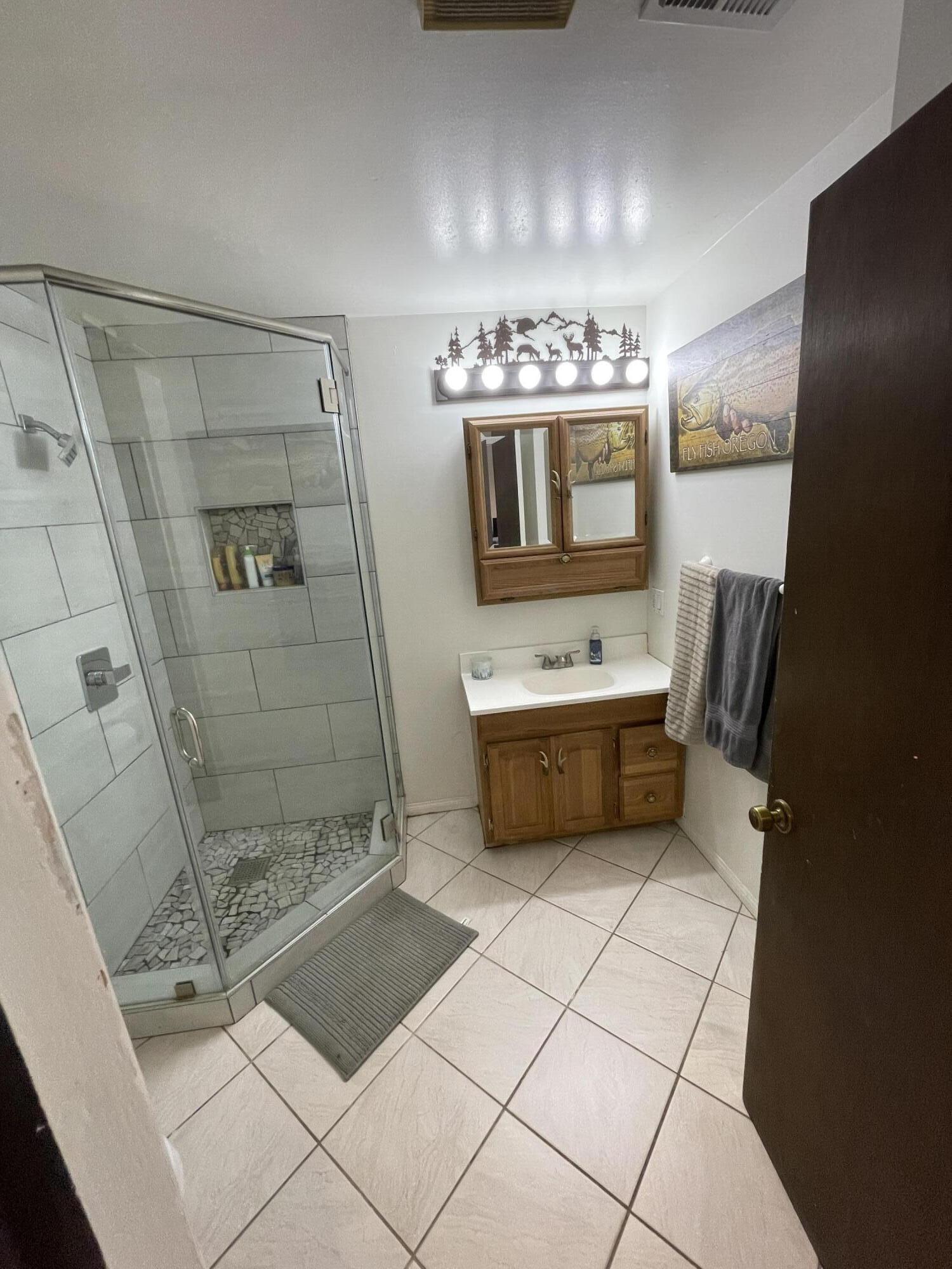 38540 Alva Drive Cherry Valley, CA 92223 - Photo 23 of 60 a bathroom with a sink a toilet and shower