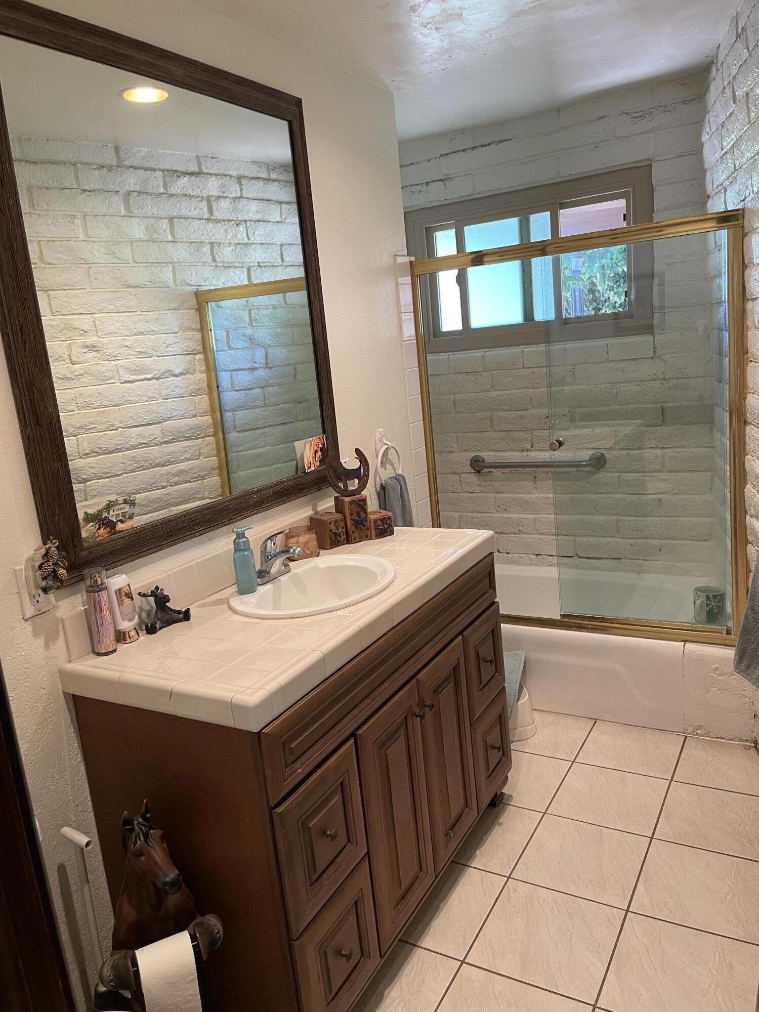 38540 Alva Drive Cherry Valley, CA 92223 - Photo 24 of 60 a bathroom with a sink vanity and a mirror