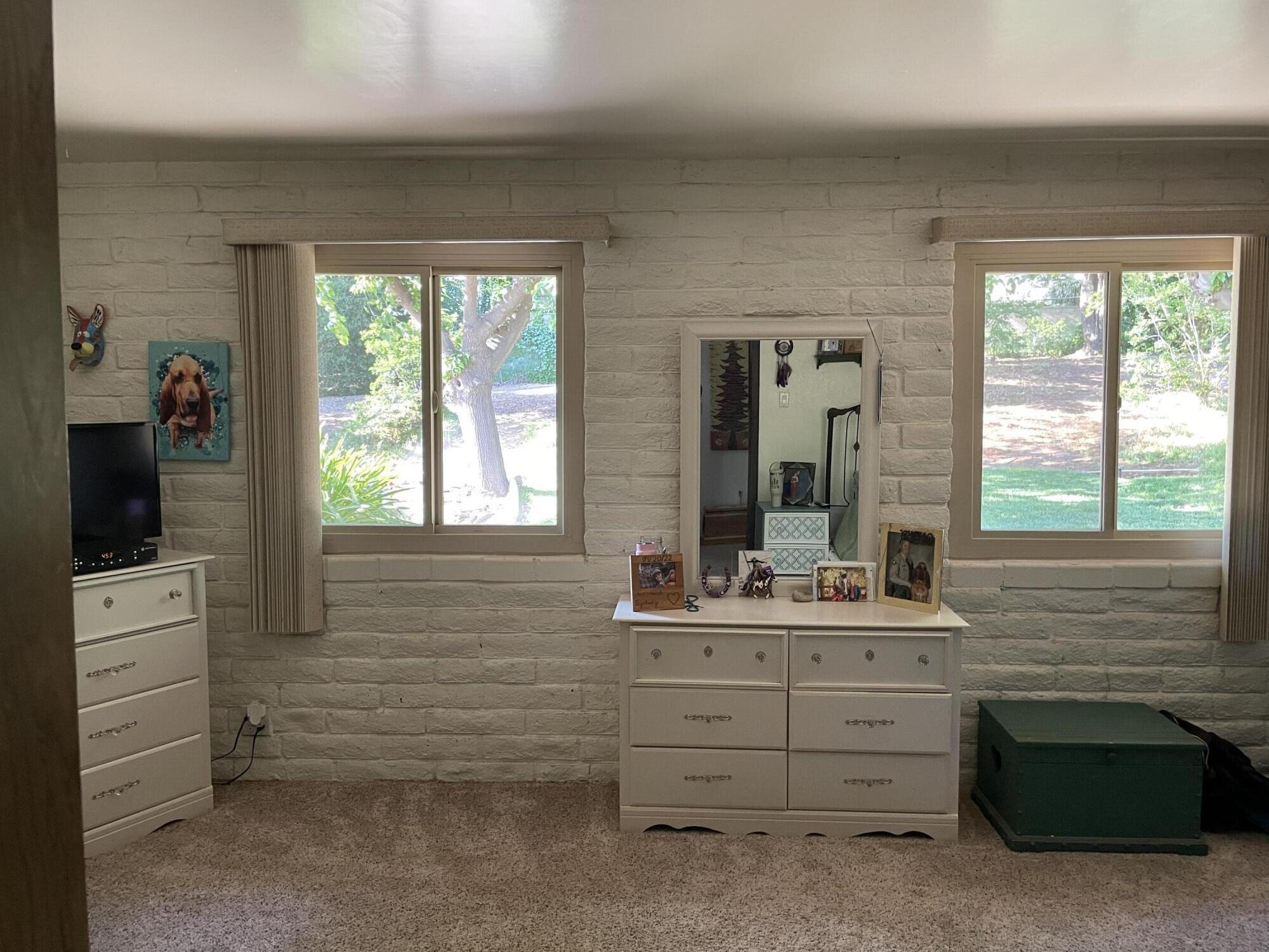 38540 Alva Drive Cherry Valley, CA 92223 - Photo 26 of 60 a bathroom with a sink a large mirror and a window