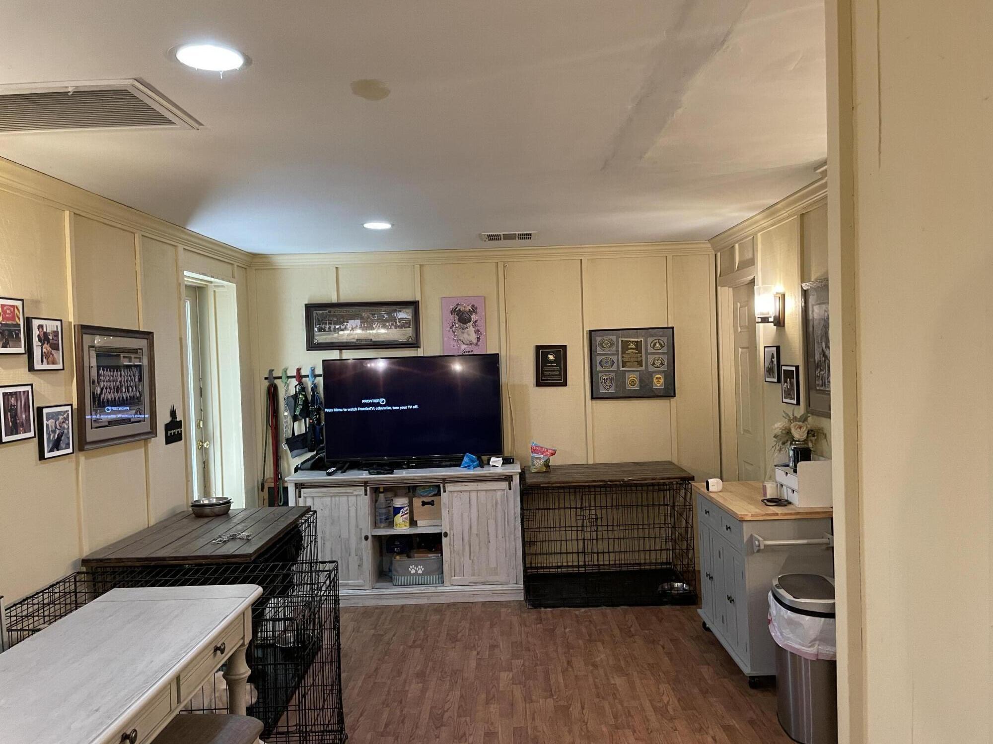 38540 Alva Drive Cherry Valley, CA 92223 - Photo 40 of 60 a living room with a flat screen tv a rug and a walk in closet