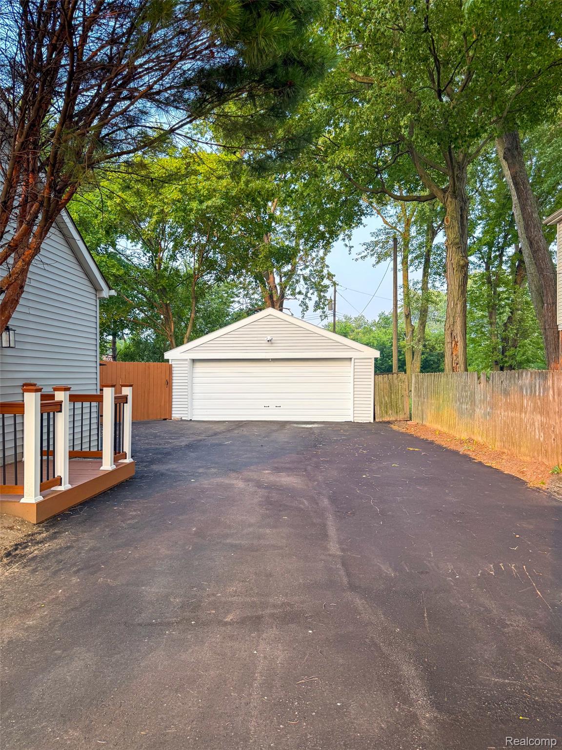 30052 Schoenherr Road Warren, MI 48088 - Photo 36 of 38 Detached two-car garage with a white panel door and light-colored siding
