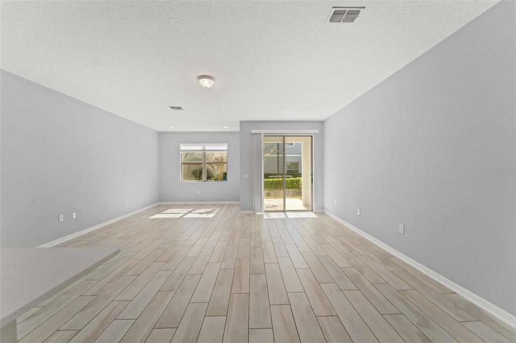 229 Rustic Loop Sanford, FL 32771 - Photo 13 of 38 wooden floor in an empty room with a window