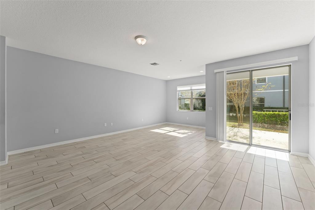229 Rustic Loop Sanford, FL 32771 - Photo 14 of 38 a view of empty room with wooden floor and fan