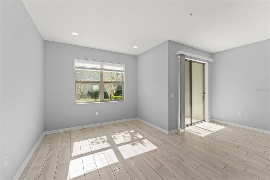 229 Rustic Loop Sanford, FL 32771 - Photo 15 of 38 wooden floor in an empty room with a window