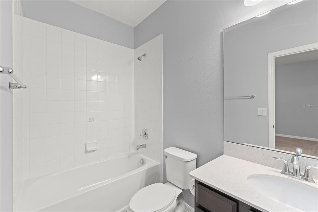 229 Rustic Loop Sanford, FL 32771 - Photo 25 of 38 a bathroom with a sink toilet and bathtub