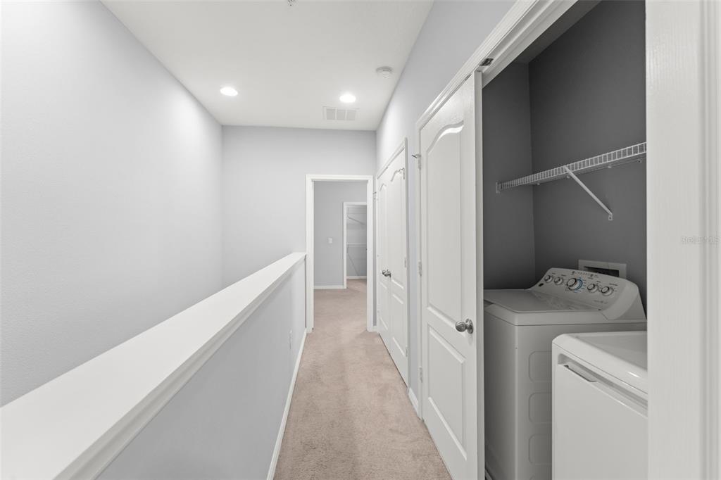 229 Rustic Loop Sanford, FL 32771 - Photo 26 of 38 a view of hallway with washer and dryer