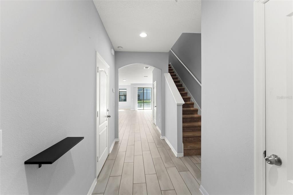 229 Rustic Loop Sanford, FL 32771 - Photo 3 of 38 wooden floor in a hall with a window