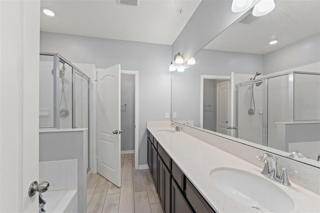 229 Rustic Loop Sanford, FL 32771 - Photo 31 of 38 a bathroom with a double vanity sink mirror and shower
