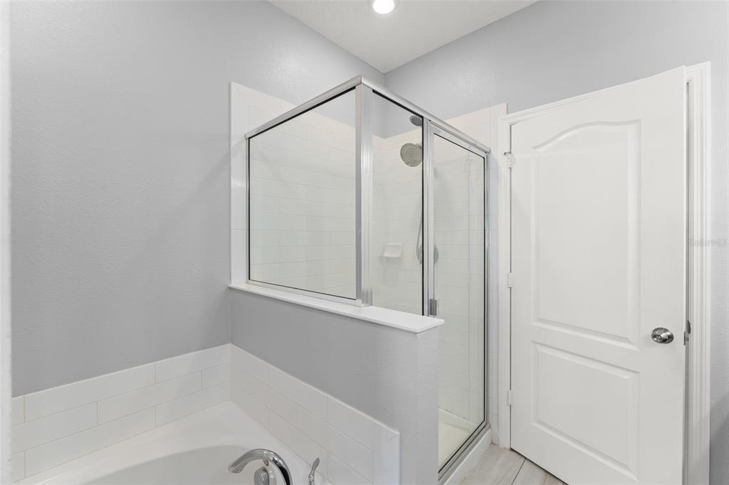 229 Rustic Loop Sanford, FL 32771 - Photo 32 of 38 a bathroom with a bathtub and a shower