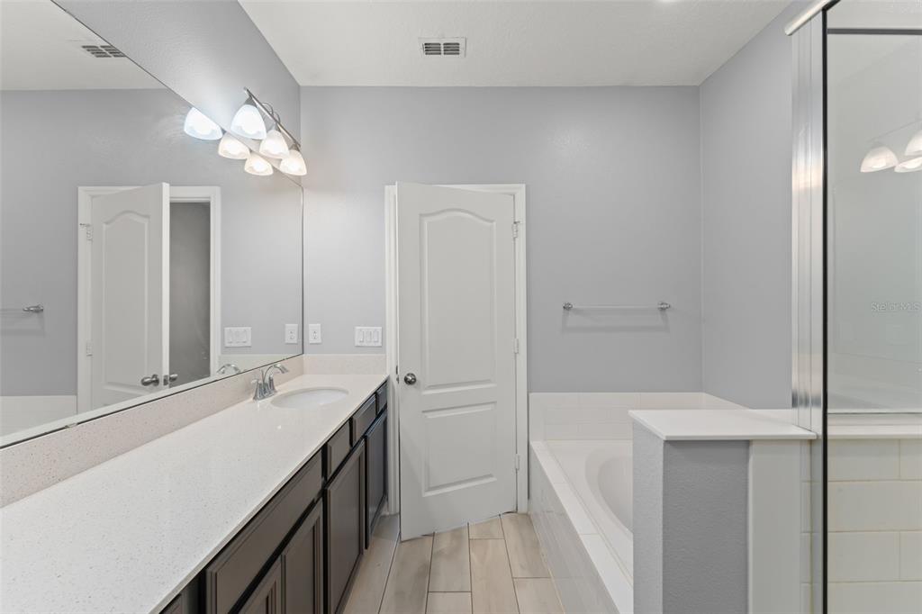 229 Rustic Loop Sanford, FL 32771 - Photo 33 of 38 a bathroom with a sink a vanity and a mirror