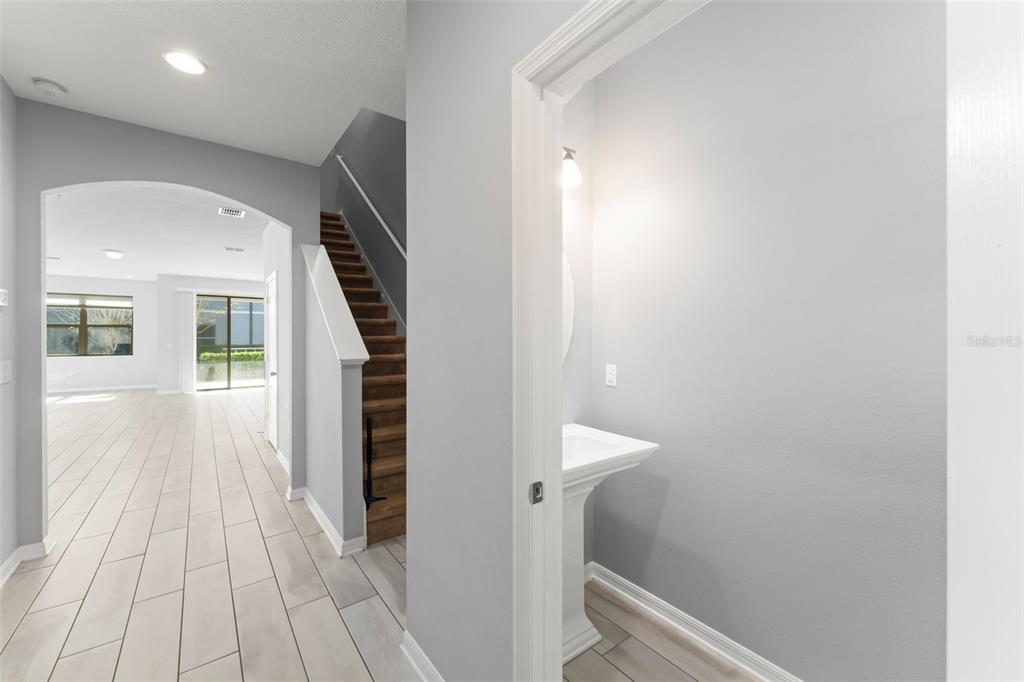 229 Rustic Loop Sanford, FL 32771 - Photo 5 of 38 a view of a hallway with wooden floor and staircase