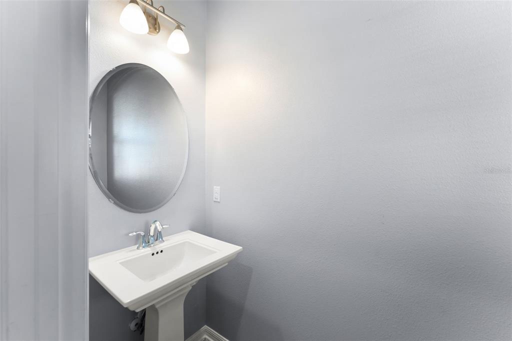 229 Rustic Loop Sanford, FL 32771 - Photo 6 of 38 a bathroom with a sink and mirror