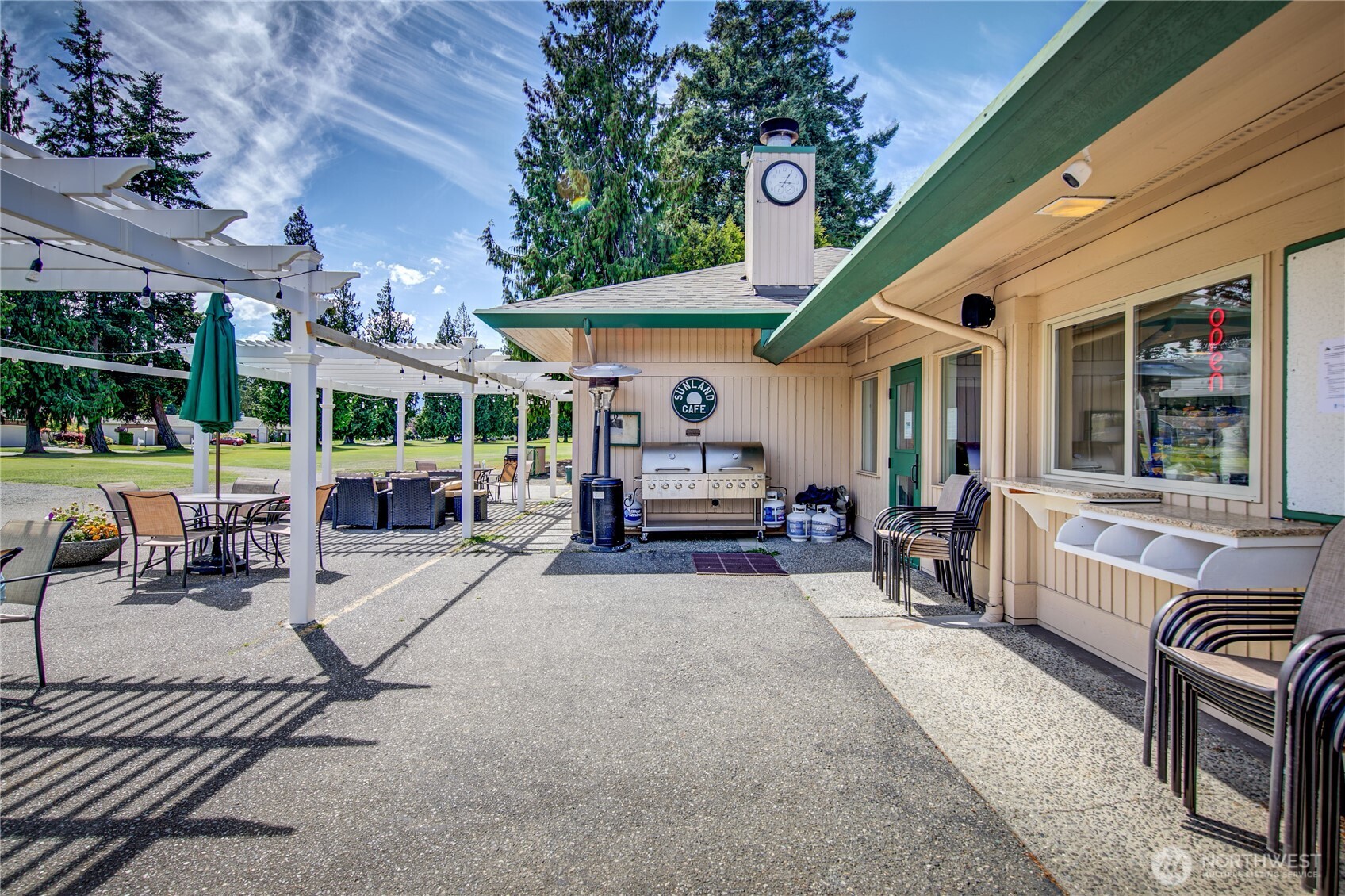 0 Vancouver Place Sequim, WA 98382 - Photo 12 of 26 a view of a patio with table and chairs potted plants and a large tree