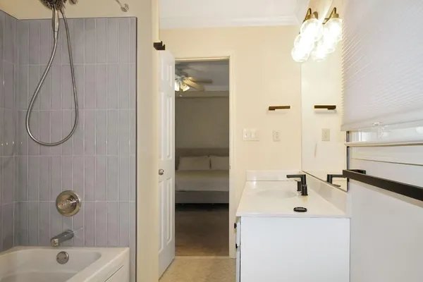 a bathroom with a sink bath tub and shower