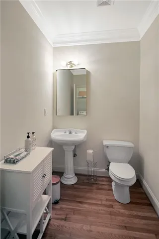 a bathroom with a sink toilet and a mirror