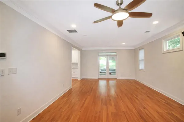 wooden floor in an empty room with a window