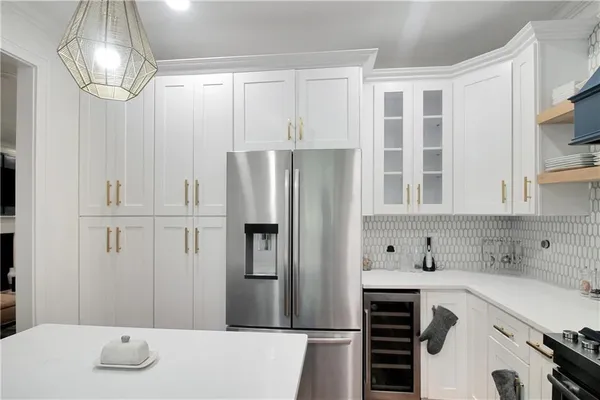 a kitchen with cabinets and stainless steel appliances