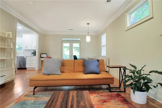 a living room with furniture potted plant and a table
