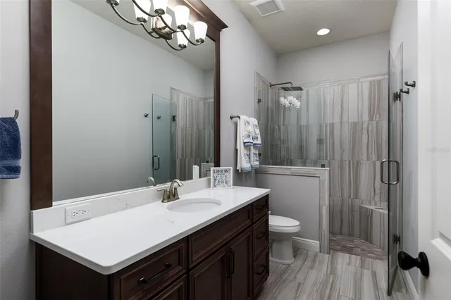 a spacious bathroom with a tub sink and mirror