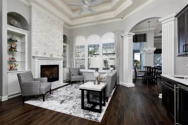 a kitchen with a sink a stove a refrigerator and white cabinets