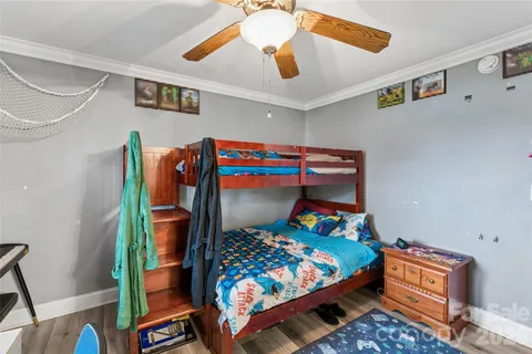 a bedroom with a bed and a baby bed