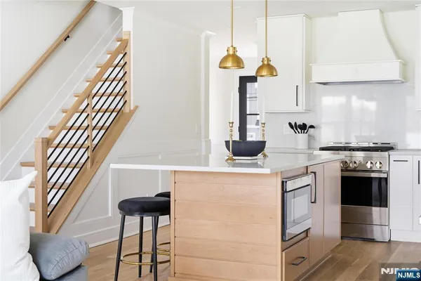 a living room with furniture a fireplace and a large window