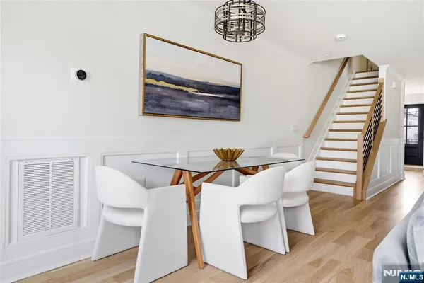 a living room with stainless steel appliances kitchen island granite countertop furniture and a wooden floor