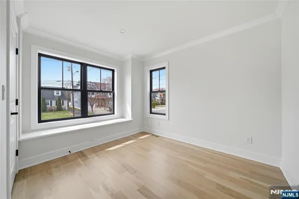 a spacious bedroom with a bed and a window