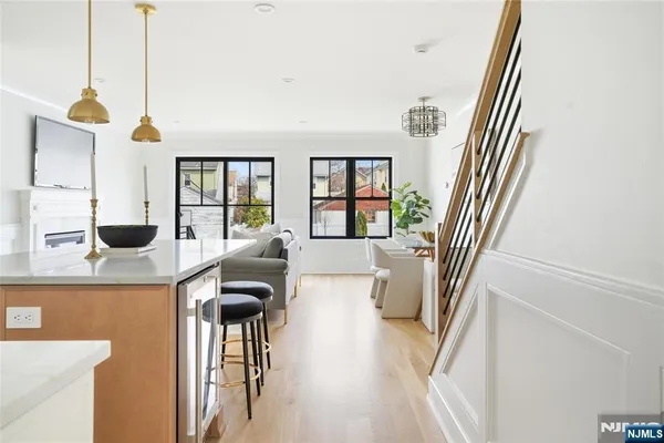a kitchen with stainless steel appliances granite countertop a stove and white cabinets