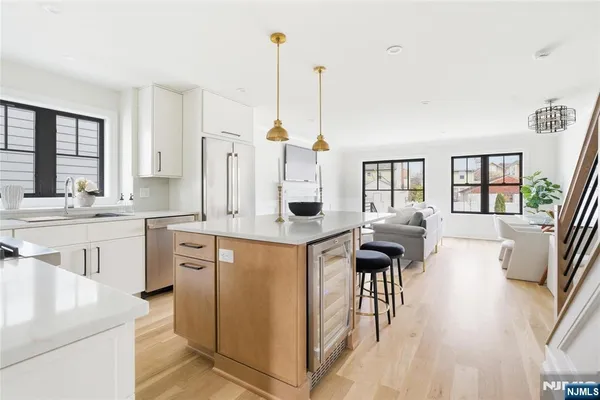 a kitchen with stainless steel appliances granite countertop a sink stove and cabinets