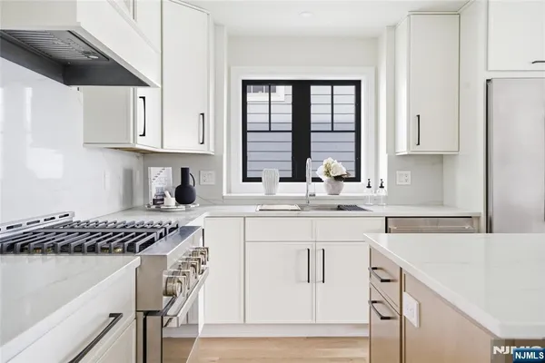 a kitchen with a stove and a white cabinets