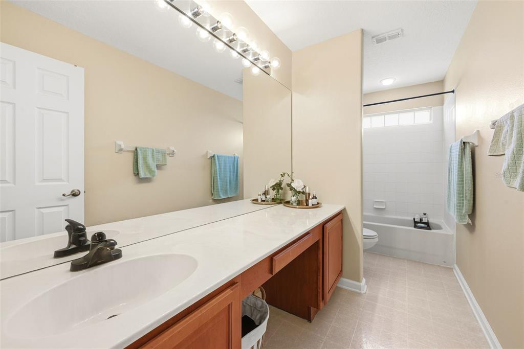936 Kingsridge Circle Gotha, FL 34734 - Photo 23 of 50 a bathroom with a sink and a mirror