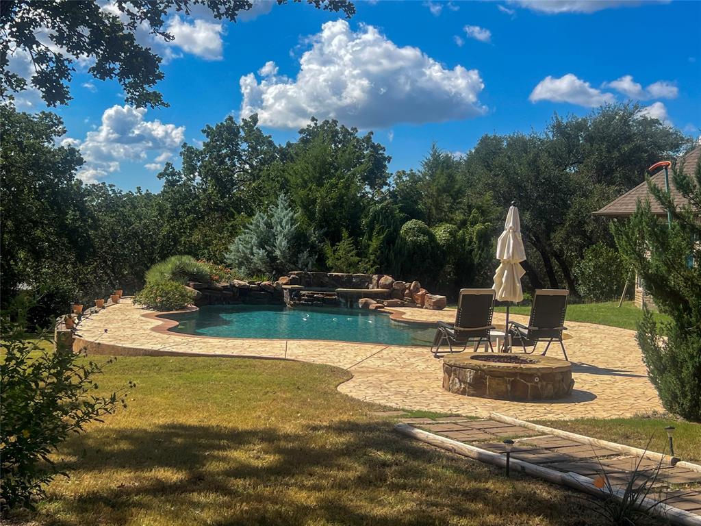 a view of a swimming pool with a chair and tables